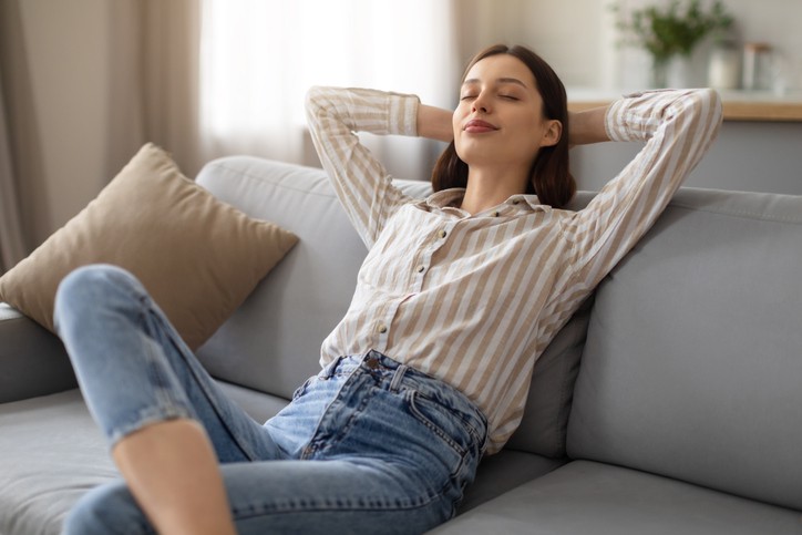 Woman leaning back on sofa, breathing comfortably because of proper airflow